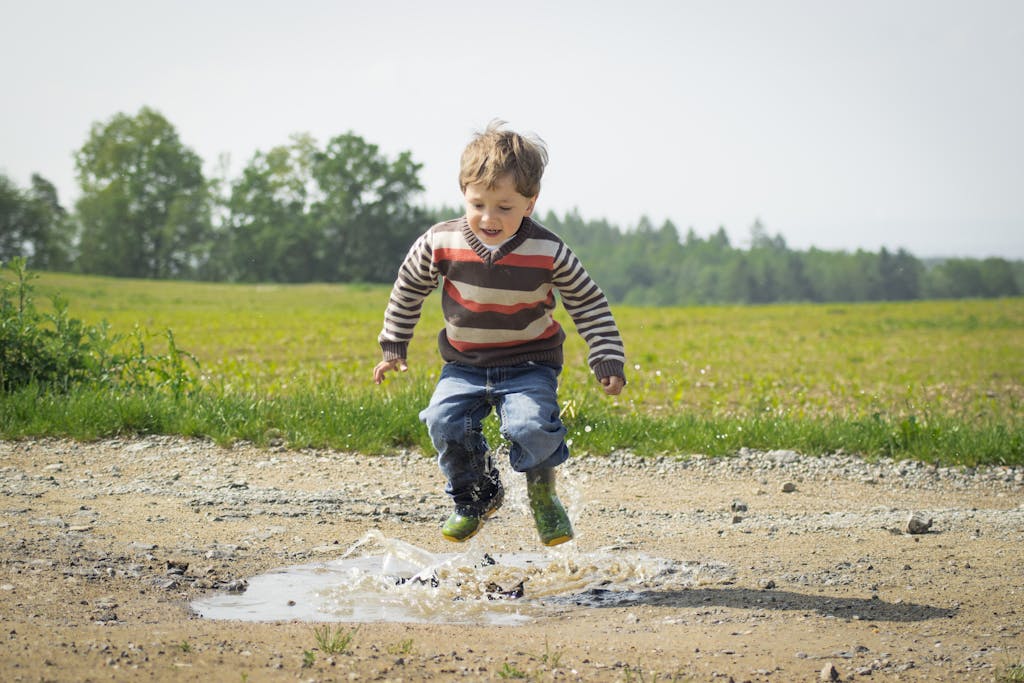Happy homeschooled child jumping and learning through play